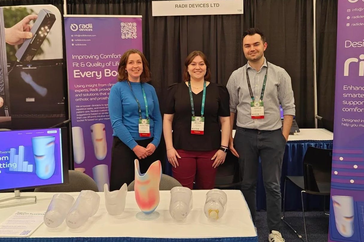 Radii Devices team at conference booth showcasing riiForm